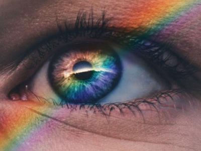 An eye with a rainbow prism over it